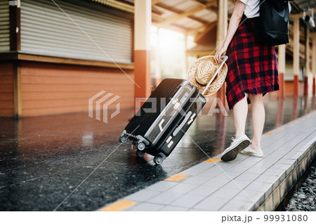 summer, relax, vacation, travel, portrait of cute Asian girl showing smile and showing joy while waiting at the train station for a summer trip summer, relax, vacation, travel, portrait of cute Asian girl showing smile and showing joy while waiting at the train station for a summer trip 99931080
