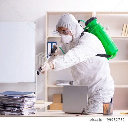 Professional contractor doing pest control at office 99932782
