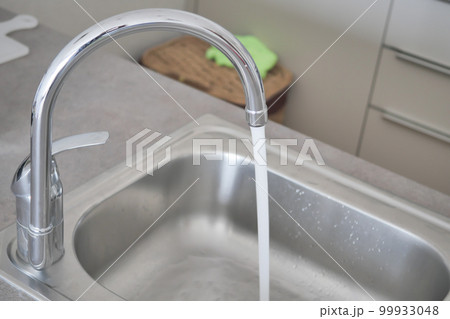 water pouring from a faucet tap slow motion water pouring from a faucet tap slow motion 99933048