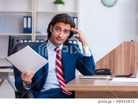 Young male businessman working in the office Young male businessman working in the office 99933872