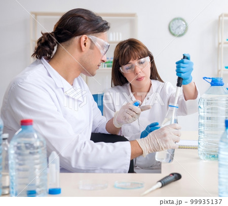 Two chemists working in the lab Two chemists working in the lab 99935137