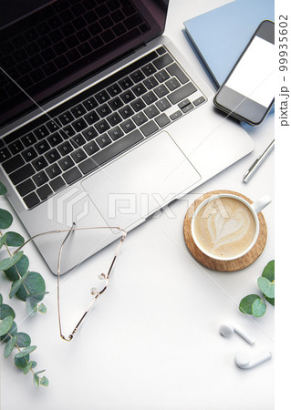 Office desk table with laptop, supplies and coffee cup Office desk table with laptop, supplies and coffee cup 99935602