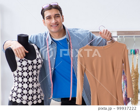 Male tailor with female student in workshop Male tailor with female student in workshop 99937222