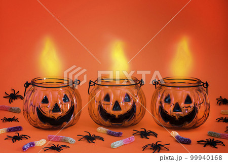 Halloween pumpkin,jack o lantern, luminous isolated on bright orange background. Halloween holiday party. Halloween pumpkin,jack o lantern, luminous isolated on bright orange background. Halloween holiday party. 99940168