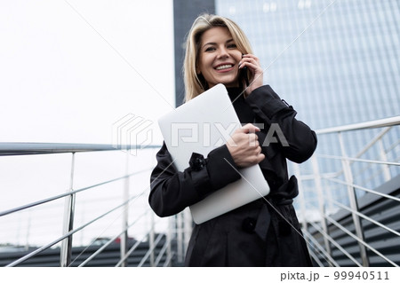 optimist woman stands against the backdrop of a financial bank 99940511