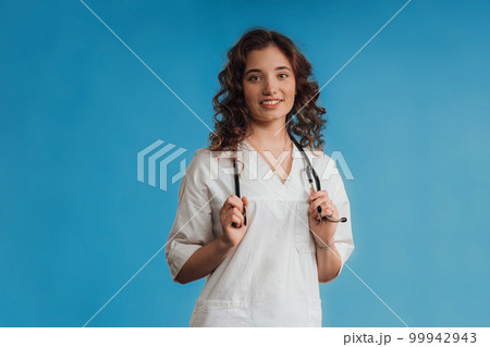 Portrait of young curly nurse, studio shoot. Portrait of young curly nurse, studio shoot. 99942943