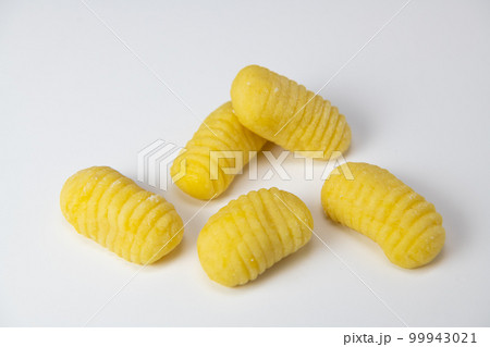 Pile of yellow eggs gnocchi dough dumplings isolated over the white background Pile of yellow eggs gnocchi dough dumplings isolated over the white background 99943021