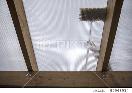 Washing the patio pergola roof cover made of aluminum. removing the dirty algae with brush soap and water close up in garden from a house terrace Washing the patio pergola roof cover made of aluminum. removing the dirty algae with brush soap and water close up in garden from a house terrace 99943954