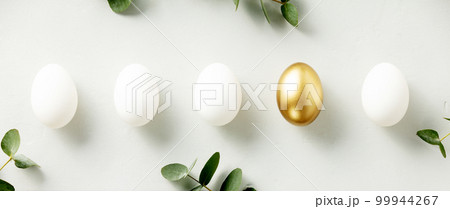 White chicken eggs with one golden egg flat lay top view banner White chicken eggs with one golden egg flat lay top view banner 99944267