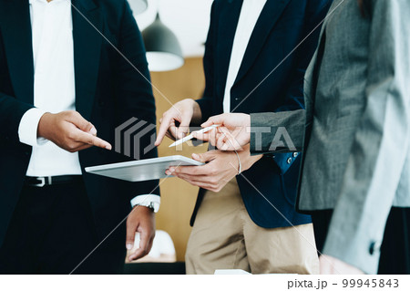 Business group people meeting and discuss to come up with conclusions on market, investment and marketing planning based on the financial budget provided by the company. 99945843