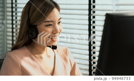 Competent female operator working on computer and while talking with clients. Competent female operator working on computer and while talking with clients. 99946733