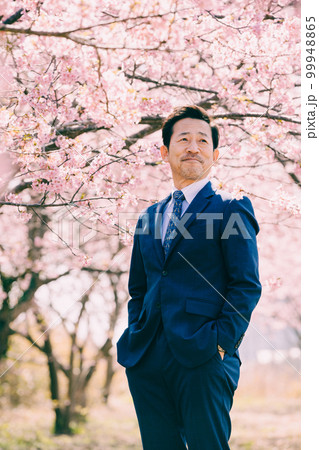 満開の桜とスーツを着たオジサン 99948865