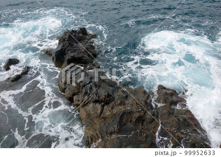 View from the drone on the waves and rocks in the ocean. View from the drone on the waves and rocks in the ocean. 99952633