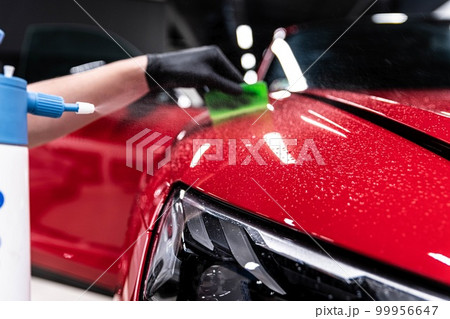 Application of a colorless protective film at a car detailing studio or car wash.  99956647