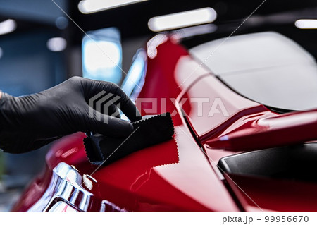 Application of ceramic coating in car detailing studio or car wash. 99956670