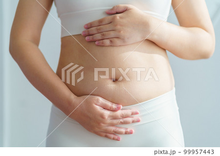 Women body fat belly. Obese woman hand holding excessive belly fat. diet lifestyle concept to reduce belly and shape up healthy stomach muscle. 99957443