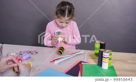 Kids papercraft. Making paper bugs out of the empty toilet paper rolls and construction paper. 99958643