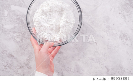 Flat lay. Step by step. Ingredients in a glass mixing bowl to prepare cream cheese frosting. Flat lay. Step by step. Ingredients in a glass mixing bowl to prepare cream cheese frosting. 99958892
