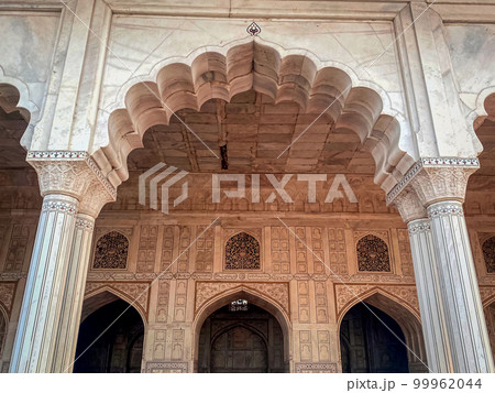 The famous red fort in the city of Agra, India. Tourists visit a popular tourist attraction. 99962044