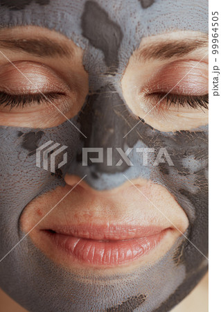 Closeup on modern woman with cosmetic mask Closeup on modern woman with cosmetic mask 99964505
