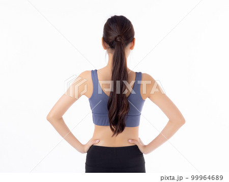 Portrait of beautiful young asian woman in sportwear smile and showing waist and abs. 99964689