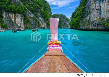 Traveling with long tail boat on fantastic emerald lagoon sea at Koh Phi Phi Island Thailand, Pileh Lagoon 99965502