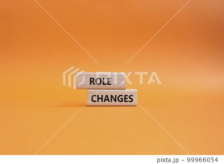 Role changes symbol. Concept words Role changes on wooden blocks. Beautiful orange background. Business and Role changes concept. Copy space. 99966054