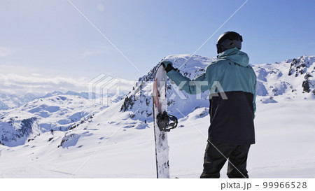 Snowboarder stay with snowboard in hands. Snowboarder stay with snowboard in hands. 99966528