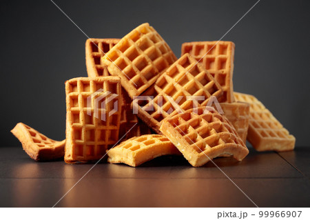Belgian waffles on a black background. Belgian waffles on a black background. 99966907