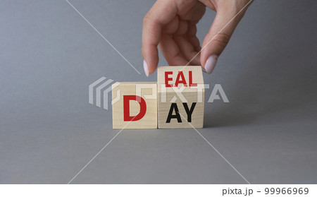 Deal of the Day symbol. Businessman hand Turnes cube and changes word Day to Deal. Beautiful grey background. Business and Deal of the Day concept. Copy space 99966969