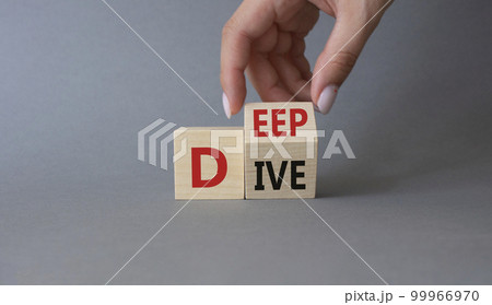 Deep Dive symbol. Businessman hand. Concept words deep dive on wooden cubes. Beautiful grey background. Business and Deep Dive concept. Copy space 99966970