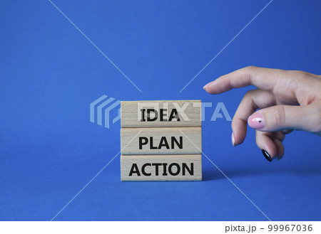 Idea Plan Action symbol. Wooden blocks with words Idea Plan Action. Businessman hand. Beautiful blue background. Business and Idea Plan Action concept. Copy space. 99967036