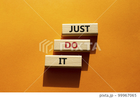 Just do it symbol. Wooden blocks with words Just do it. Beautiful orange background. Business and Just do it concept. Copy space. Just do it symbol. Wooden blocks with words Just do it. Beautiful orange background. Business and Just do it concept. Copy space. 99967065