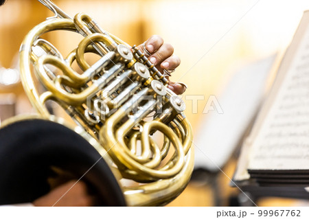 French horn instrument, hands playing horn player in philharmonic orchestra 99967762