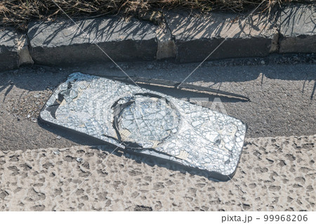 Broken truck side mirror on the street. 99968206