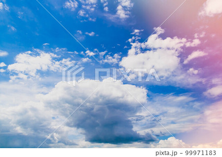 White clouds in bright sunlight. Revival of day. Clouds in glare of sun. 99971183