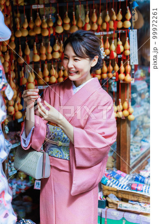 観光地で土産物を探す着物を着た若い女性 99972261