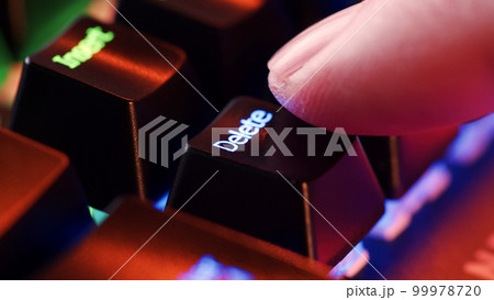 Person is in doubt whether to press the Delete key or not. Heavy decision do it or not. 99978720