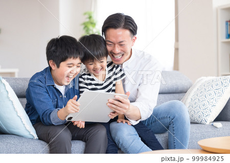 家族のポートレート タブレットを見る家族 家族のポートレート タブレットを見る家族 99984925