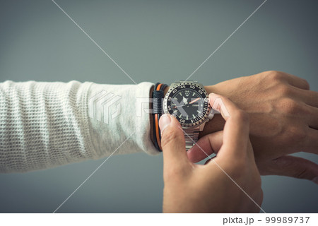 watch on wrist of man watch on wrist of man 99989737