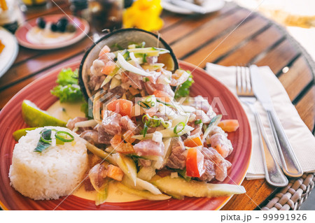 Tahiti food National dish local typical cuisine - Tahitian Raw Fish salad called Poisson Cru in French Polynesia. Top view of hotel restaurant meal in Bora Bora 99991926