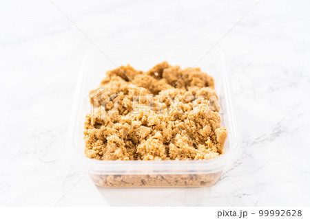 Light brown sugar on a marble counter top. 99992628