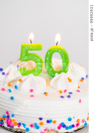 Little birthday cake for 50th birthday on a white cake plate. 99992631