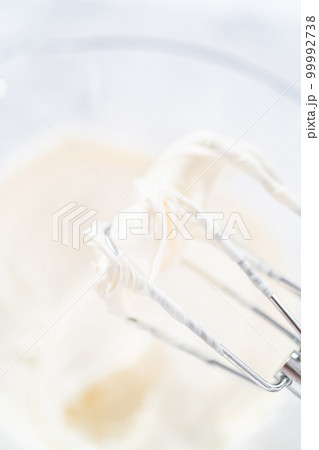 Preparing vanilla buttercream frosting for decorating funfettti bundt cake. Preparing vanilla buttercream frosting for decorating funfettti bundt cake. 99992738