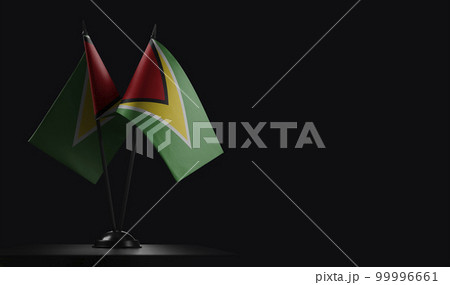 Small national flags of the Guyana on a black background 99996661
