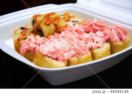 Sushi rolls in a white plastic container. Food delivery 99998196
