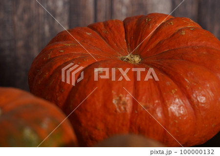 A close up photo of a bright orange pumpkin with early stages of fungal damage grey mold 100000132