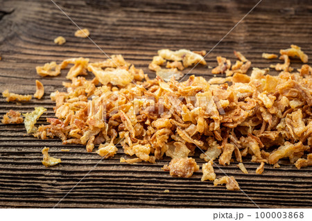Dried onions on dark rustic wooden background. 100003868