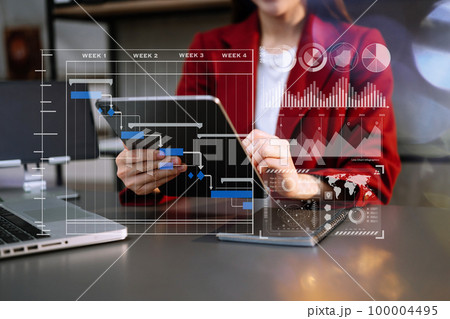 Businesswoman hand Project manager working and .pdate tasks and Gantt chart scheduling virtual diagram.with smart phone, tablet and laptop in modern office. Businesswoman hand Project manager working and .pdate tasks and Gantt chart scheduling virtual diagram.with smart phone, tablet and laptop in modern office. 100004495