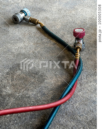 Air Conditioner Charging Hose on the rough concrete flooring 100005308